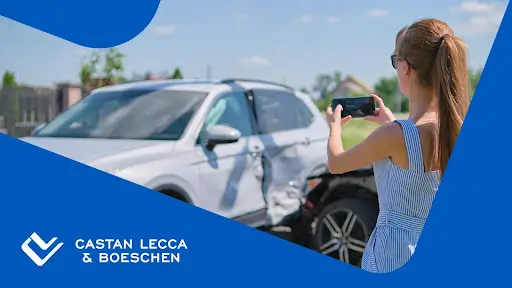 Woman taking a photo as evidence for a car accident